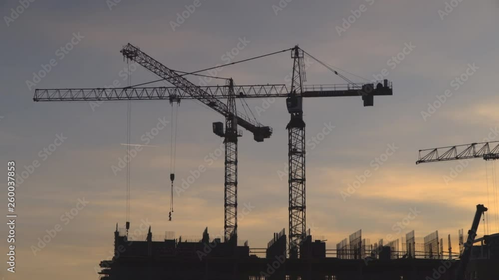 Cranes working day and night on construction of the housing estate in former industrial zone, Cranes working day and night on construction of the housing estate in former industrial zone,