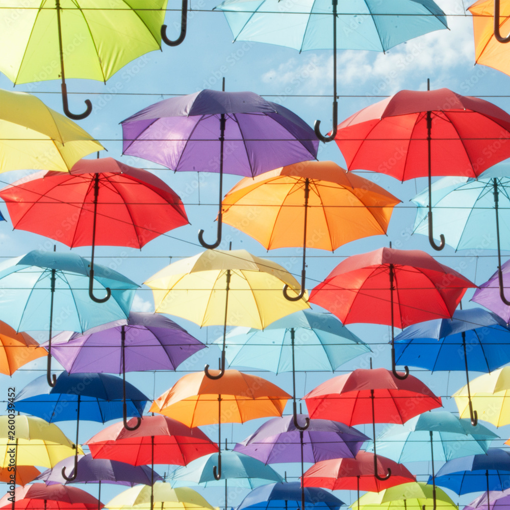Multi-colored umbrellas against the sky