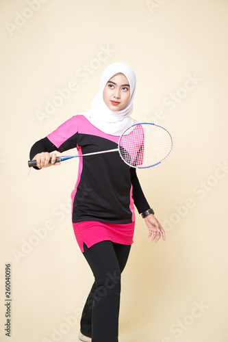 Sport Girl Wearing a Black/Pink Shirt and White Shawl Playing a Badminton