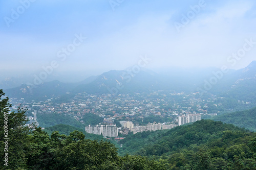 A view of a city near Seoul surrounded by mountains  seen from the North Sky Skyway.