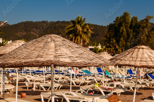 large wicker bamboo umbrellas on the beach. Turkey  Marmaris