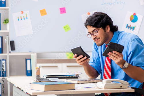 Young male financial manager working in the office 