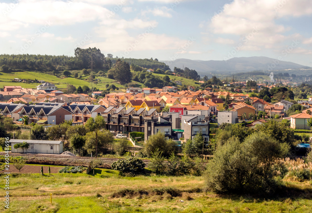 Rural town in the meadows near the mountains in Asturias in the north of Spain in a sunny day