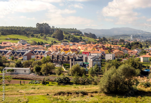 Rural town in the meadows near the mountains in Asturias in the north of Spain in a sunny day
