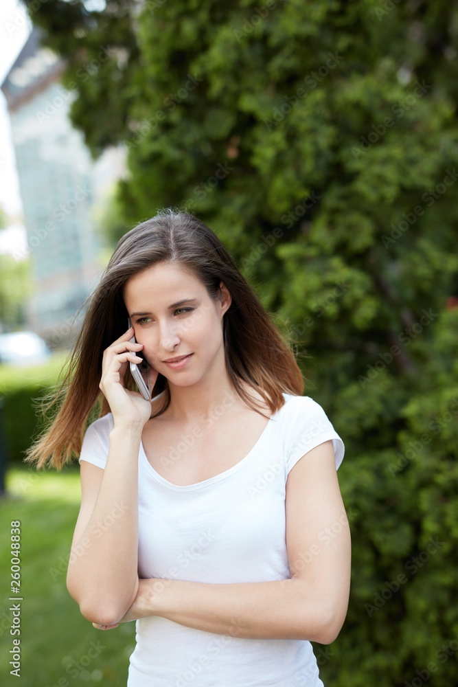 Attractive woman talking on mobile outdoors Attractive woman talking on mobile outdoors