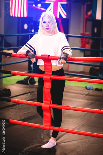 Boxer woman in boxing gloves in ring . Sexy sport blonde girl boxer posed in the ring. Fit woman boxing.