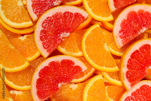 Slices of oranges and a grapefruits as a background.