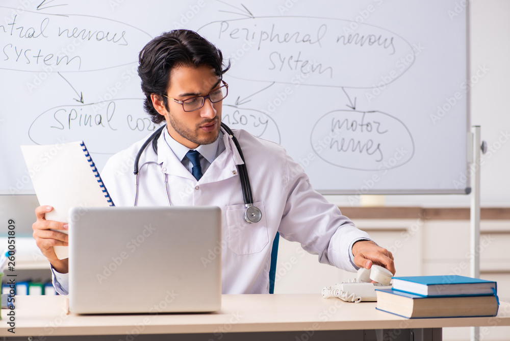 Young male doctor neurologist in front of whiteboard Young male doctor neurologist in front of whiteboard