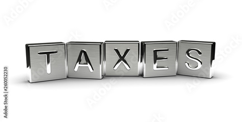 Taxes Text on Metal Block photo