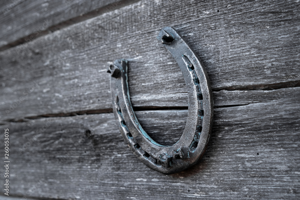 Old horseshoe on an old wooden board. The concept of luck, luck, luck. Old horseshoe on an old wooden board. The concept of luck, luck, luck.