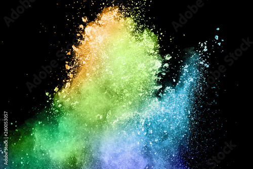 Explosion of color powder on black background. Splash of color powder dust on dark background.