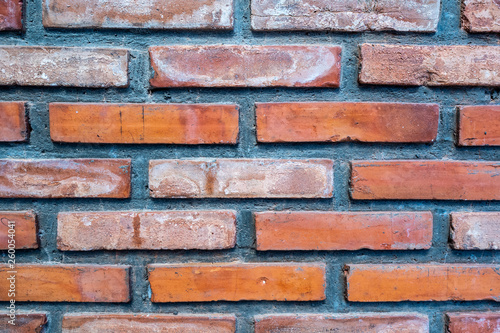 Closeup clean orange brick and cement wall for background, textured, wallpaper