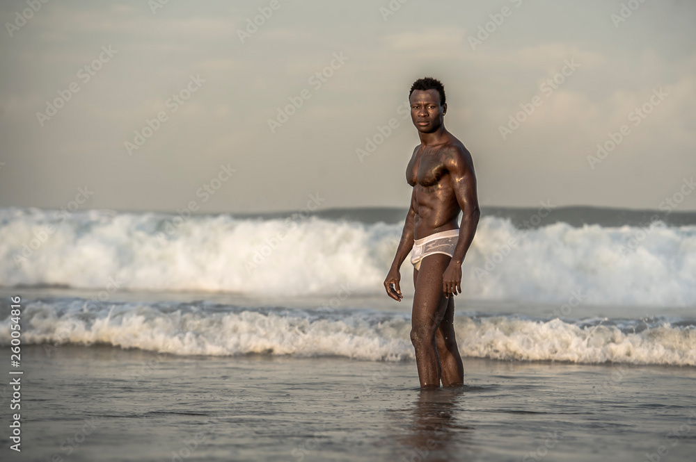 A bulky, muscular guy on the beach