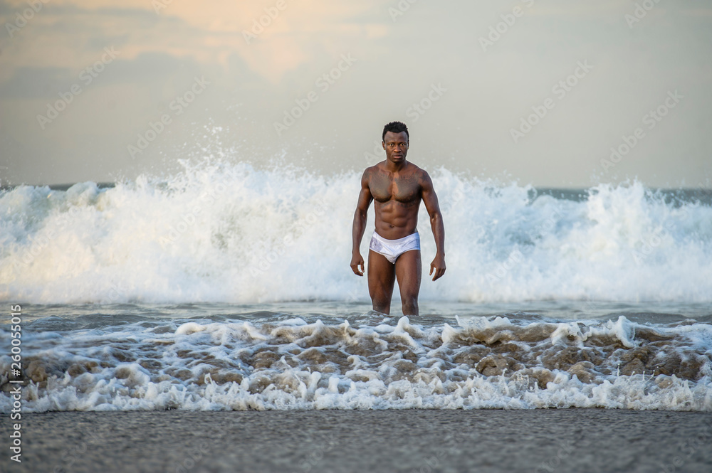 A bulky, muscular guy on the beach