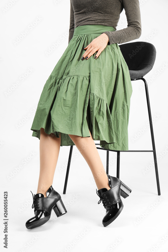 Woman in elegant shoes and bar stool on white background, closeup Woman in elegant shoes and bar stool on white background, closeup
