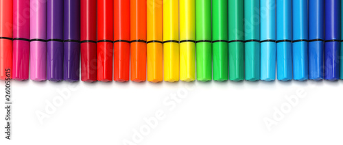 Many colorful markers on white background, top view. Rainbow palette