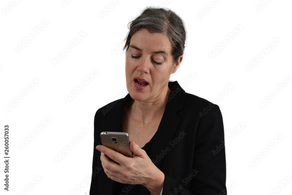 Attractive middle-aged woman with graying hair looks on her phone with a tender face. White background. Attractive middle-aged woman with graying hair looks on her phone with a tender face. White background.