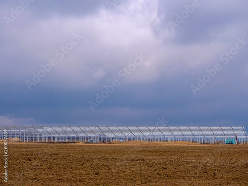 Construction of greenhouses on field. Large farm