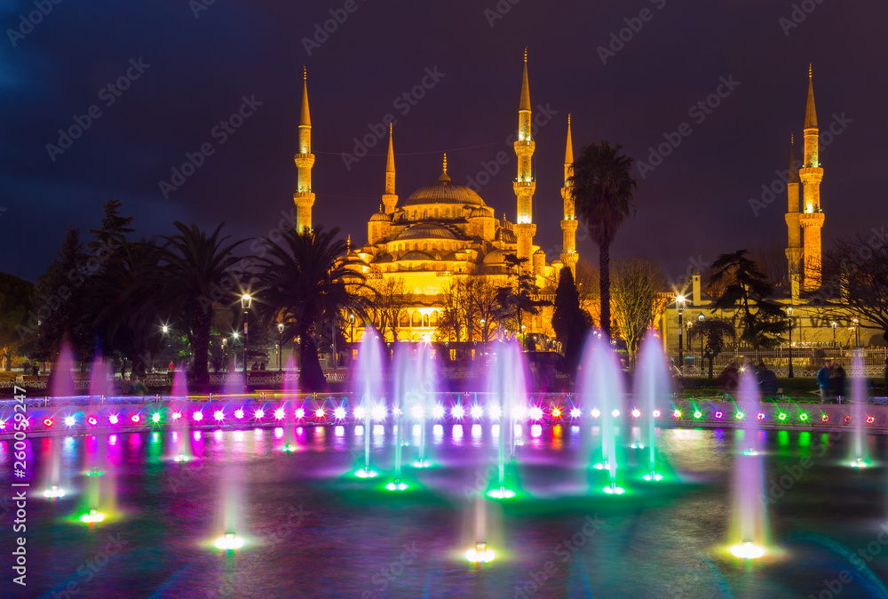 Obraz premium fountain with blue illumination on Sultanahmet square in front of the Blue mosque (Sultan Ahmed Mosque)in Istanbul in the evening