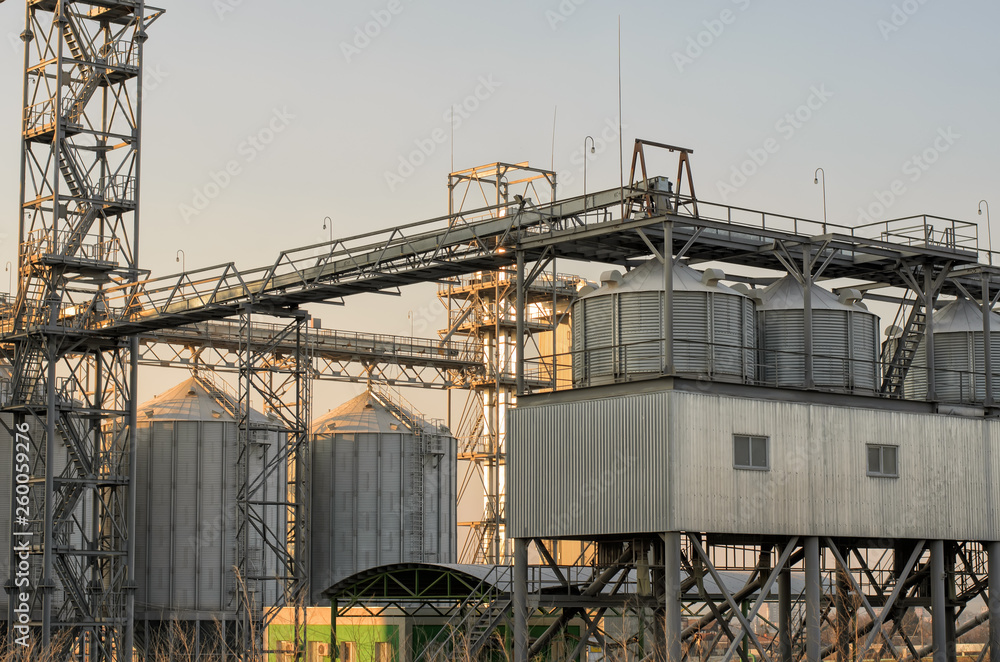 View of modern sugar beet plant, building, metal structures and equipment, including industrial silos - huge metal tanks for sugar, grain or silage storage