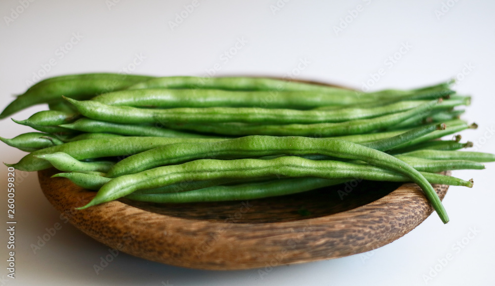 Phaseolus vulgaris or common bean on wooden plate. White background. Phaseolus vulgaris or common bean on wooden plate. White background.