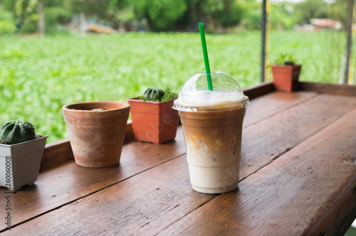 Iced coffee glass on wood table.