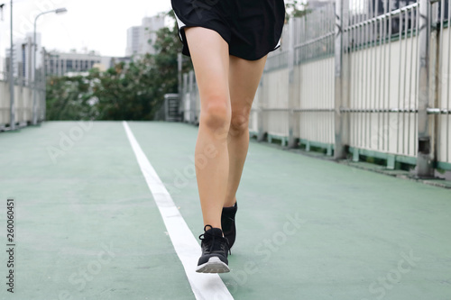 Cropped image of young runner running on street. Fitness and exercise concept.
