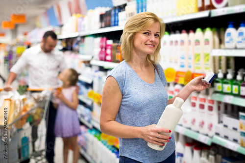 Woman customer choosing shampoo