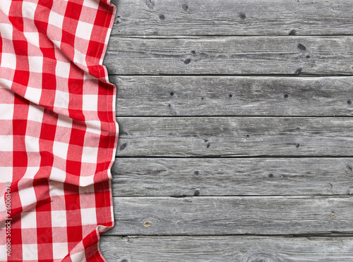 Red checkered tablecloth on wooden background