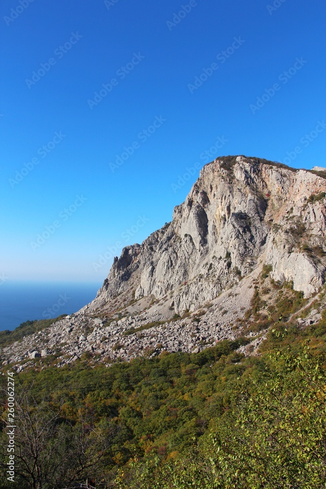View of Foros Mountain above the autumn forest on the Crimean Peninsula. It's an unofficial name of the left part of Mshatka-Kaya mountain which indeed looks like an independent mountain.