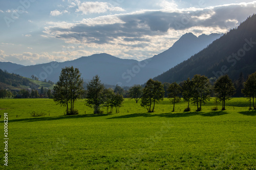 Austrian Verfenveg village Alps mountains autumnal scenery with fog, green meadows and rocks