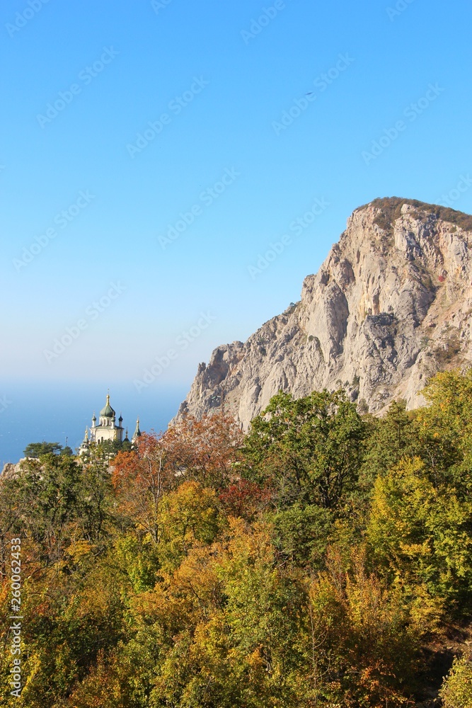 View of Foros Church, also known as The Church of Christ's Resurrection, and Foros Mount from road through the autumn forest. It's a popular tourist attraction on the outskirts of Yalta in the Crimea.