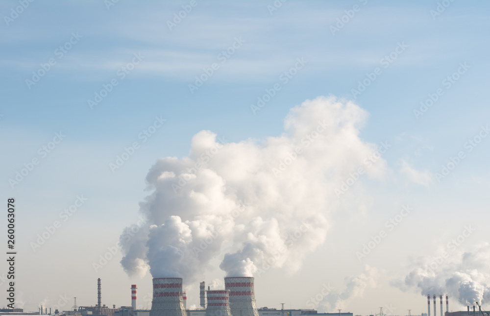 Smoking pipes of thermal power plant against blue sky Smoking pipes of thermal power plant against blue sky