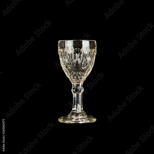 Shot glass for vodka isolated on black background.