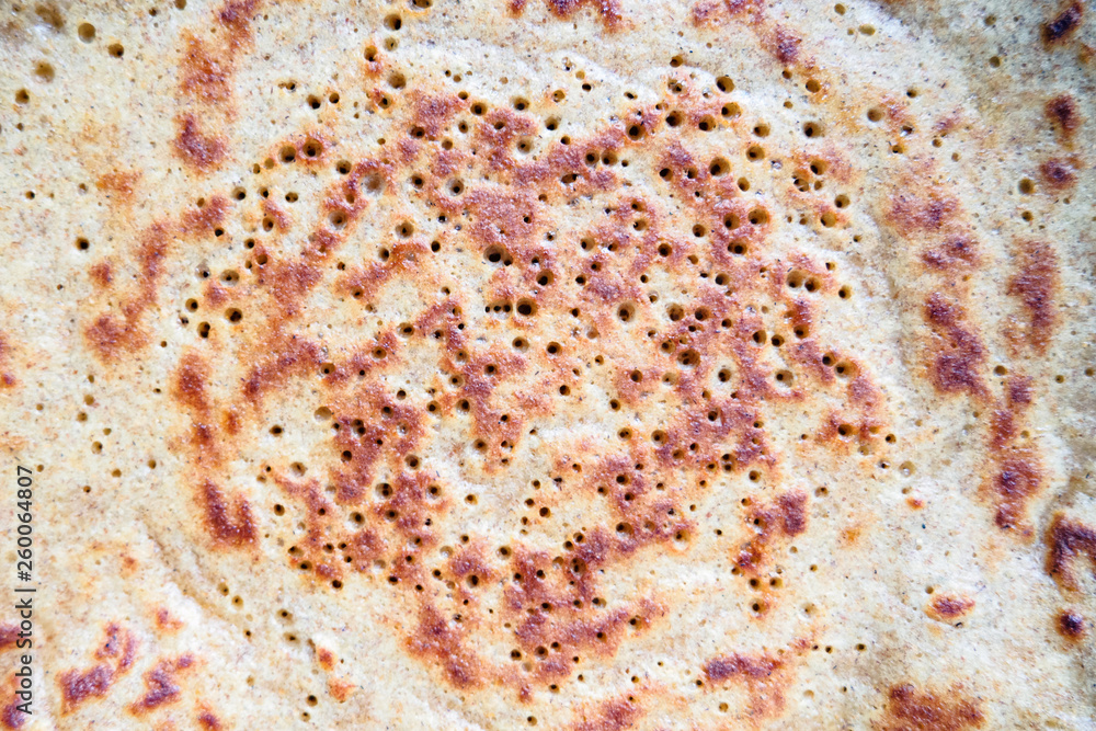 close-up of baked pancake made from rye flour, textured background close-up of baked pancake made from rye flour, textured background