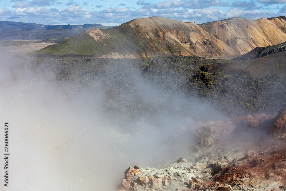 Iceland geothermal zone - area in mountains with hot springs. Cracks in mountains with hot steam.Tourist and natural attractions. Iceland geothermal zone - area in mountains with hot springs. Cracks in mountains with hot steam.Tourist and natural attractions.