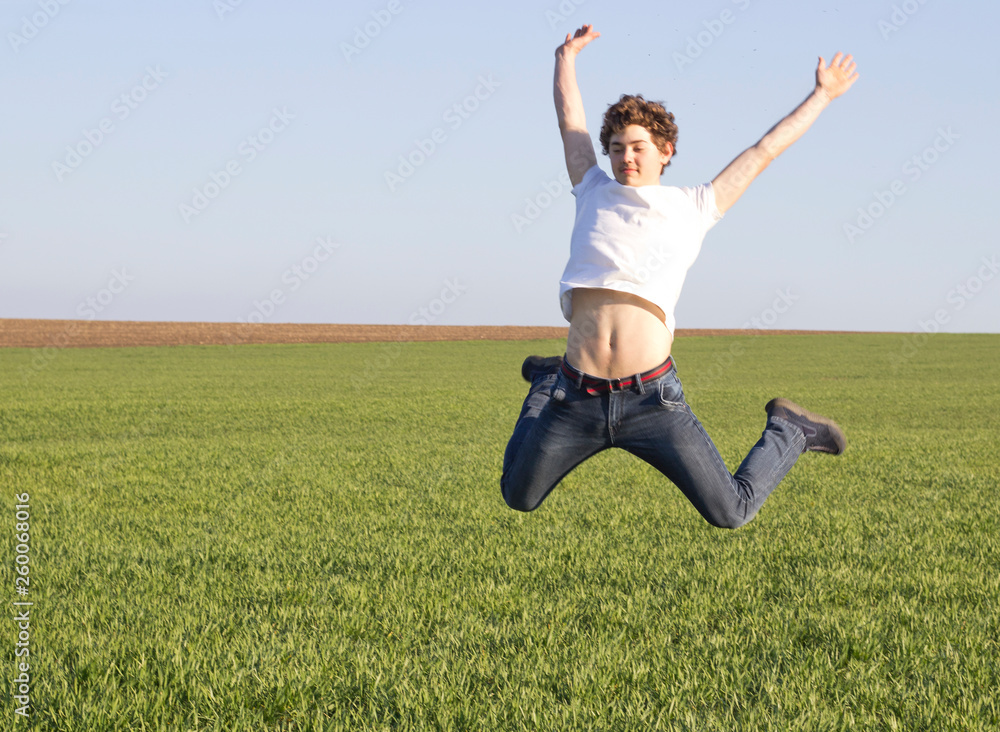 teenager in white t-shirt bouncing high up teenager in white t-shirt bouncing high up