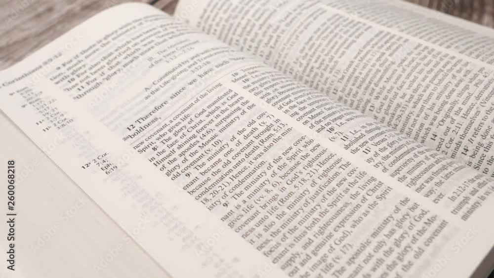 Camera turning around the holly bible being open on a table Camera turning around the holly bible being open on a table