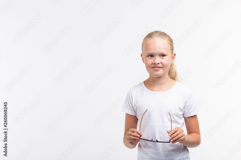 Beautiful child girl with glasses on white background with copy space Beautiful child girl with glasses on white background with copy space