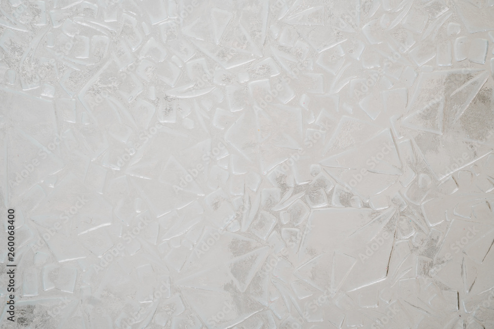 Texture of a light white corrugated glass surface