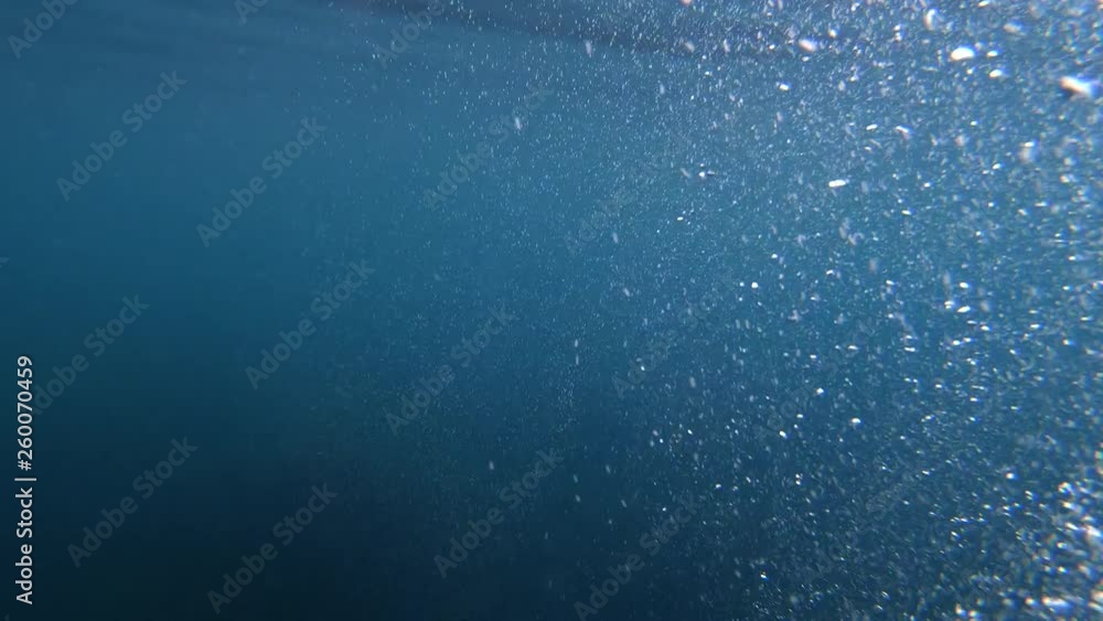 Underwater Bubbles with sunlight through water surface, natural slow motion underwater scene Underwater Bubbles with sunlight through water surface, natural slow motion underwater scene