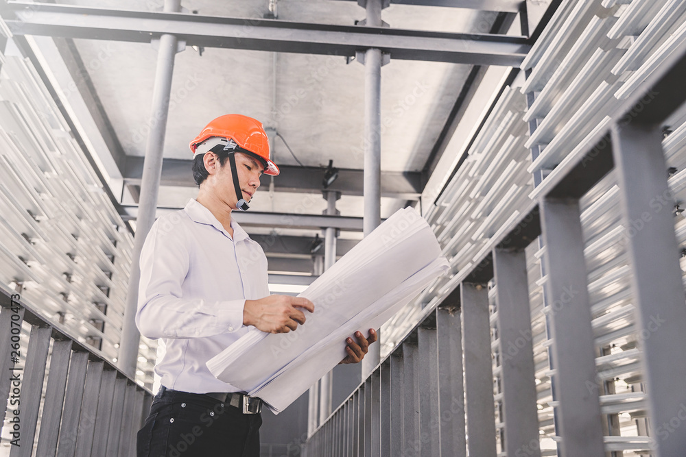 Consultant engineer discussing construction project in blueprint; Consulting concept in construction at office indoor Consultant engineer discussing construction project in blueprint; Consulting concept in construction at office indoor