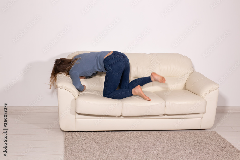 People, violence and abuse concept - Man drinking alcohol while wife is lying on sofa People, violence and abuse concept - Man drinking alcohol while wife is lying on sofa
