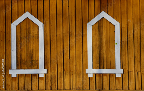 Fake white  window frames on a yellow wall