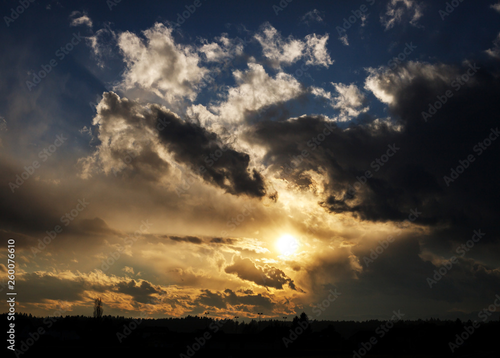 colorful golden sunset with blue sky and mighty clouds colorful golden sunset with blue sky and mighty clouds