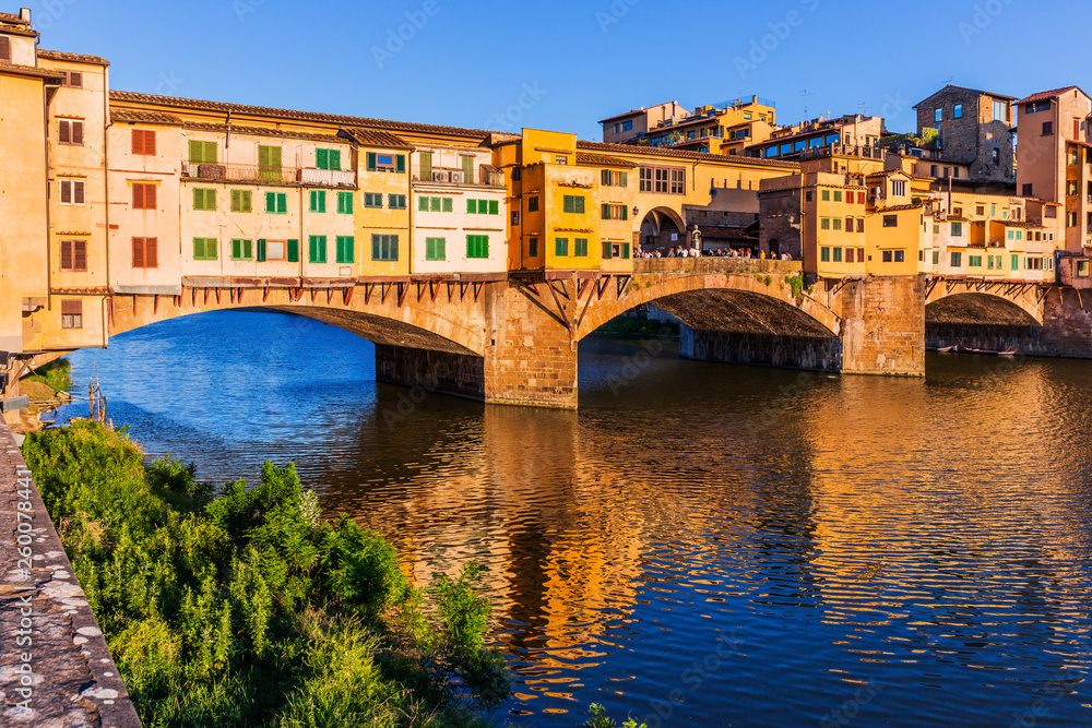 Florence, Italy. Ponte Vecchio bridge over Arno river at sunset.