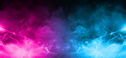 Empty background scene. Dark street, a reflection of blue and pink neon light on wet pavement. Rays of light in the dark, smoke. Night view of the street, the city. Abstract dark background.