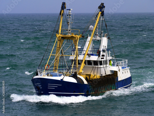 Fishing boat in choppy sea underway to harbour to discharge fish.