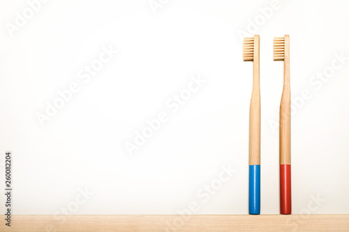 blue and red colours bamboo toothbrushes on white background. Place for text. Ecoproduct. eco-friendly.