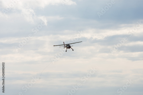 small motor plane flying in blue sky